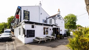 A white building with a signboard advertising 'The Old Oak Tree' and 'Live Sport Show & Pub'. - Old Oak Tree Inn (Southall)