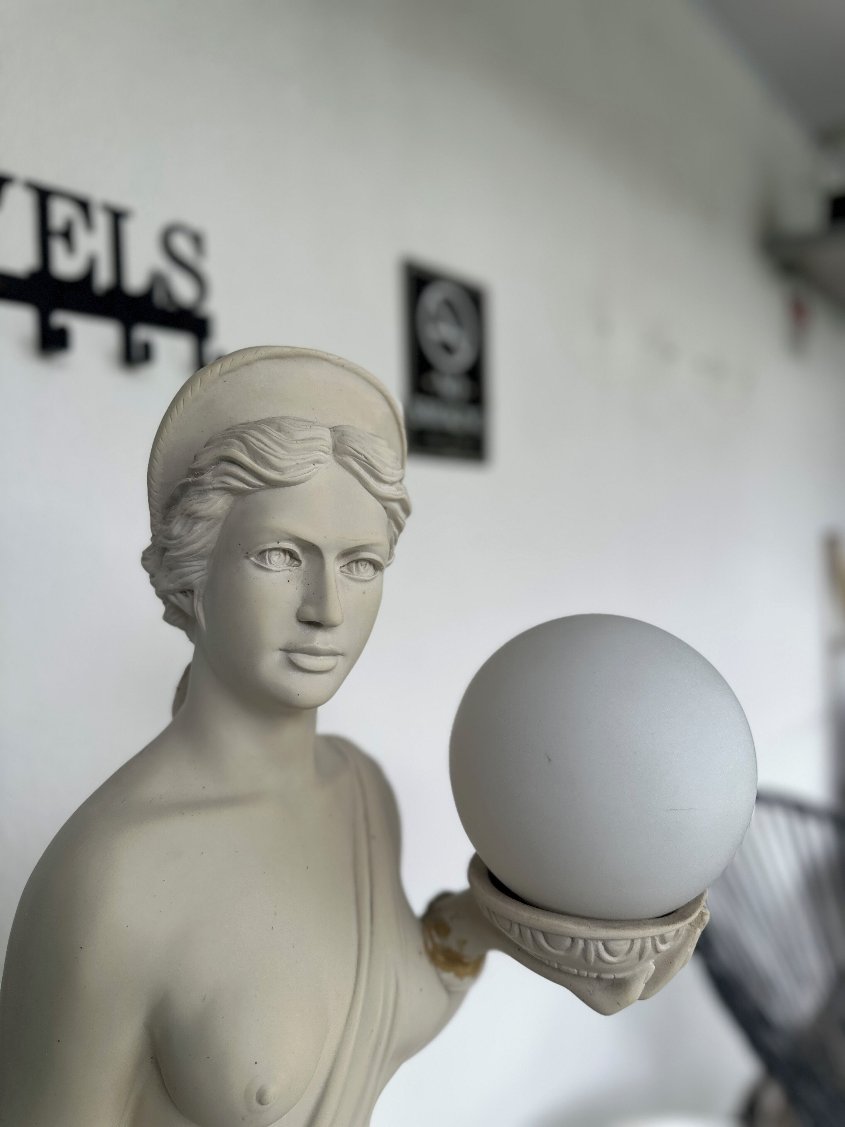 A statue of a woman holding a sphere.