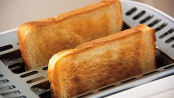 Two slices of toasted bread in a toaster.