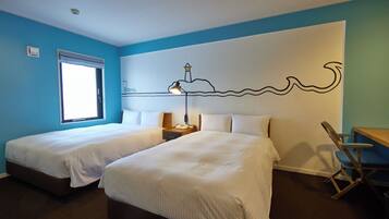 A hotel room with two beds, a desk, a chair, a window, and a wall mural.