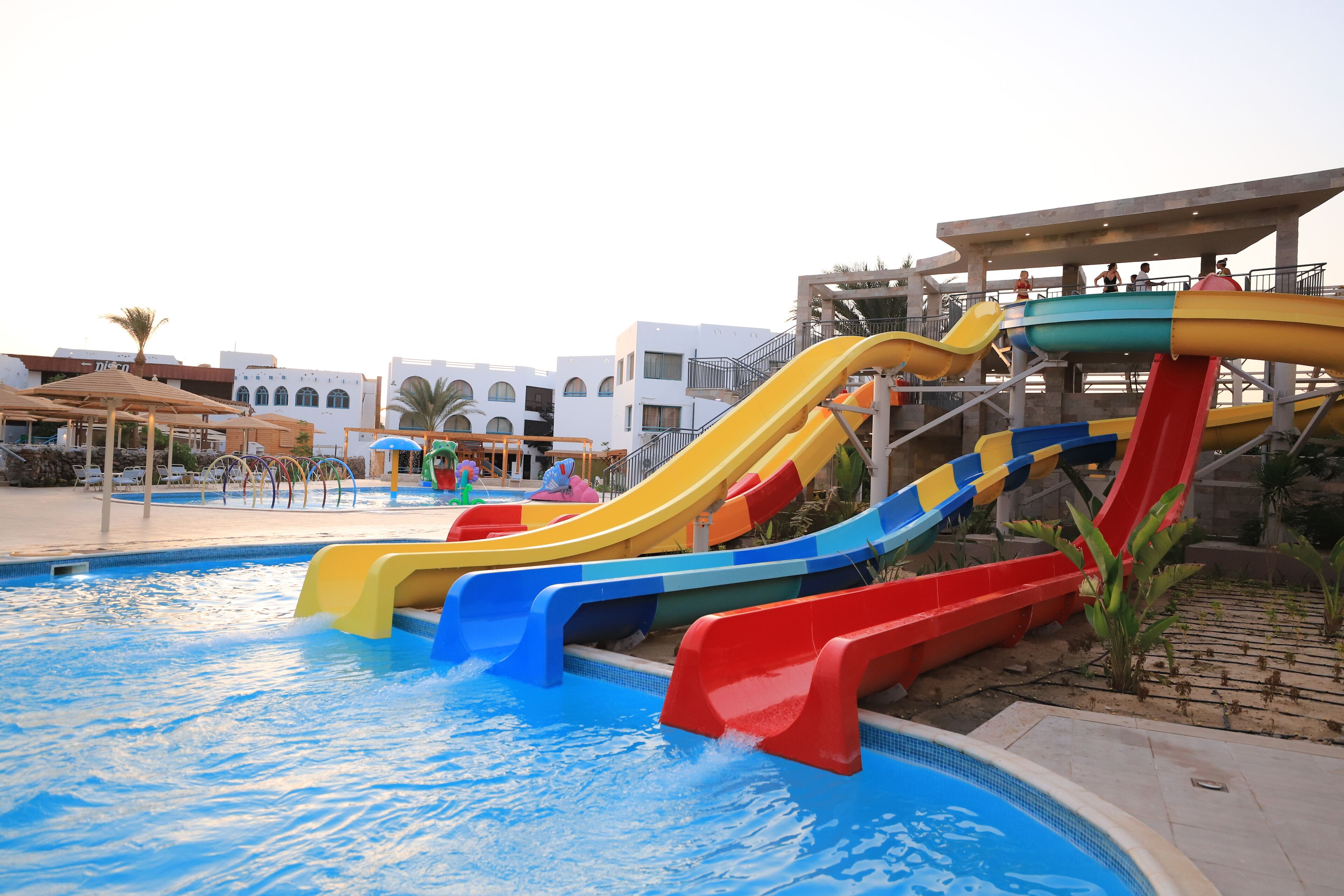 A water park with multiple slides and a pool.