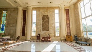 A spacious lobby with a marble floor, large windows, and a central decorative wall. - Shams Safaga Resort - All inclusive (Safaga)