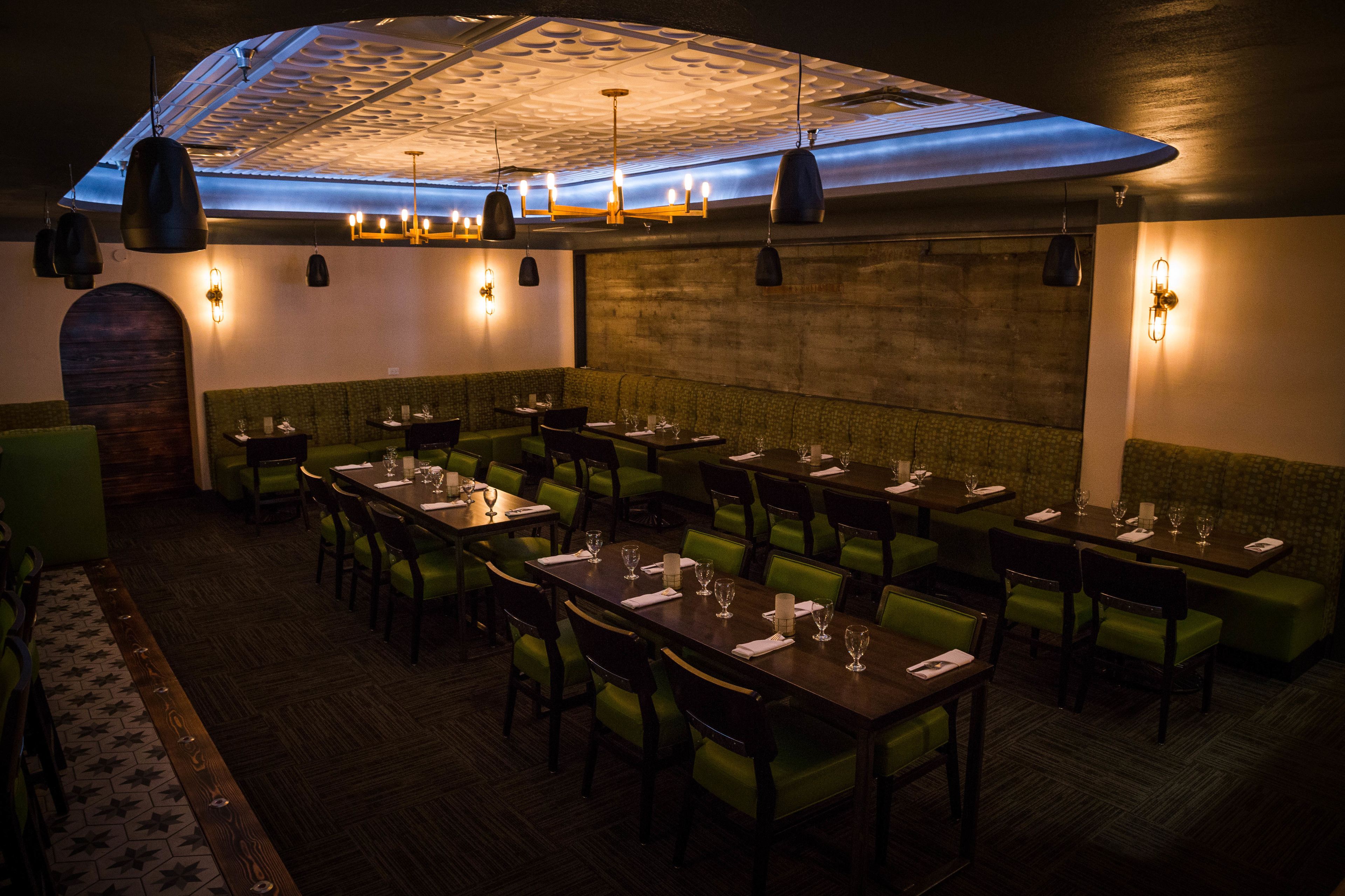 A restaurant with multiple tables and booths, each set with plates, glasses, and cutlery.