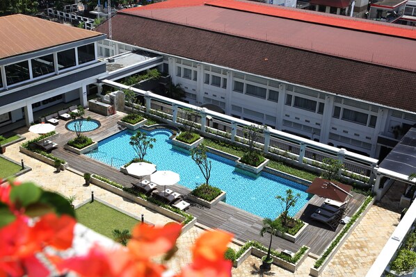 A hotel with a swimming pool, outdoor seating, and a covered area. - Grand Hotel Preanger, Bandung, a Tribute Portfolio Hotel (Bandung)
