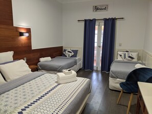 A hotel room with two beds, a wooden headboard, a desk, and a chair. - Ettalong Beach Tourist Resort (Ettalong Beach)