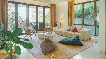 Relax in this spacious living room with a sofa set, coffee table, and cozy seating area.