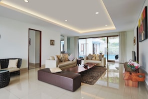 Villa | Living area | 40-inch flat-screen TV with satellite channels, plasma TV, DVD player