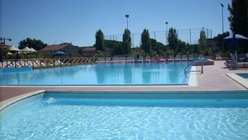 Seasonal outdoor pool, open 9:00 AM to 8:00 PM, pool umbrellas
