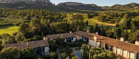 A large estate with multiple buildings, a swimming pool, and expansive gardens.