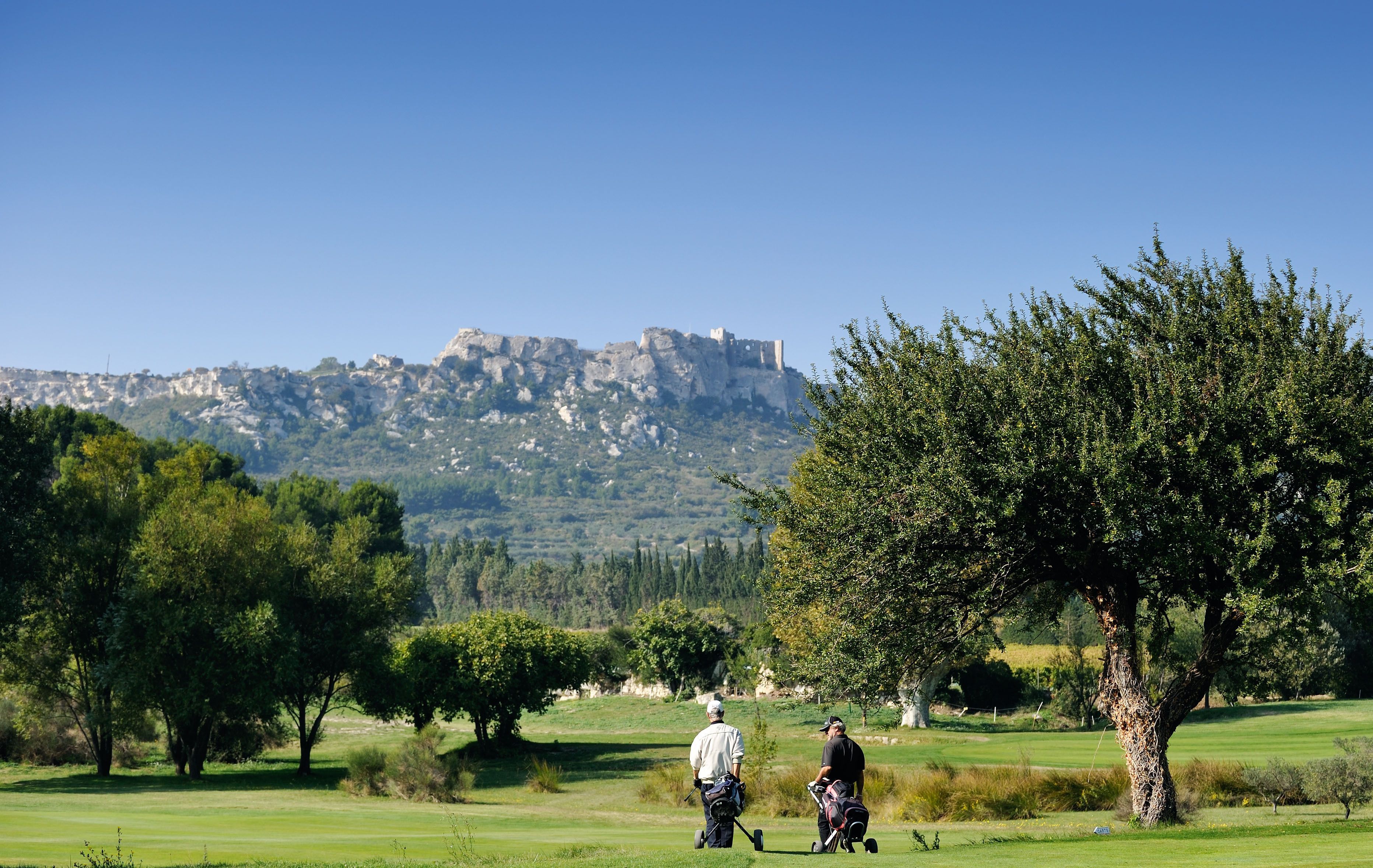 A golf course with a castle in the background.
