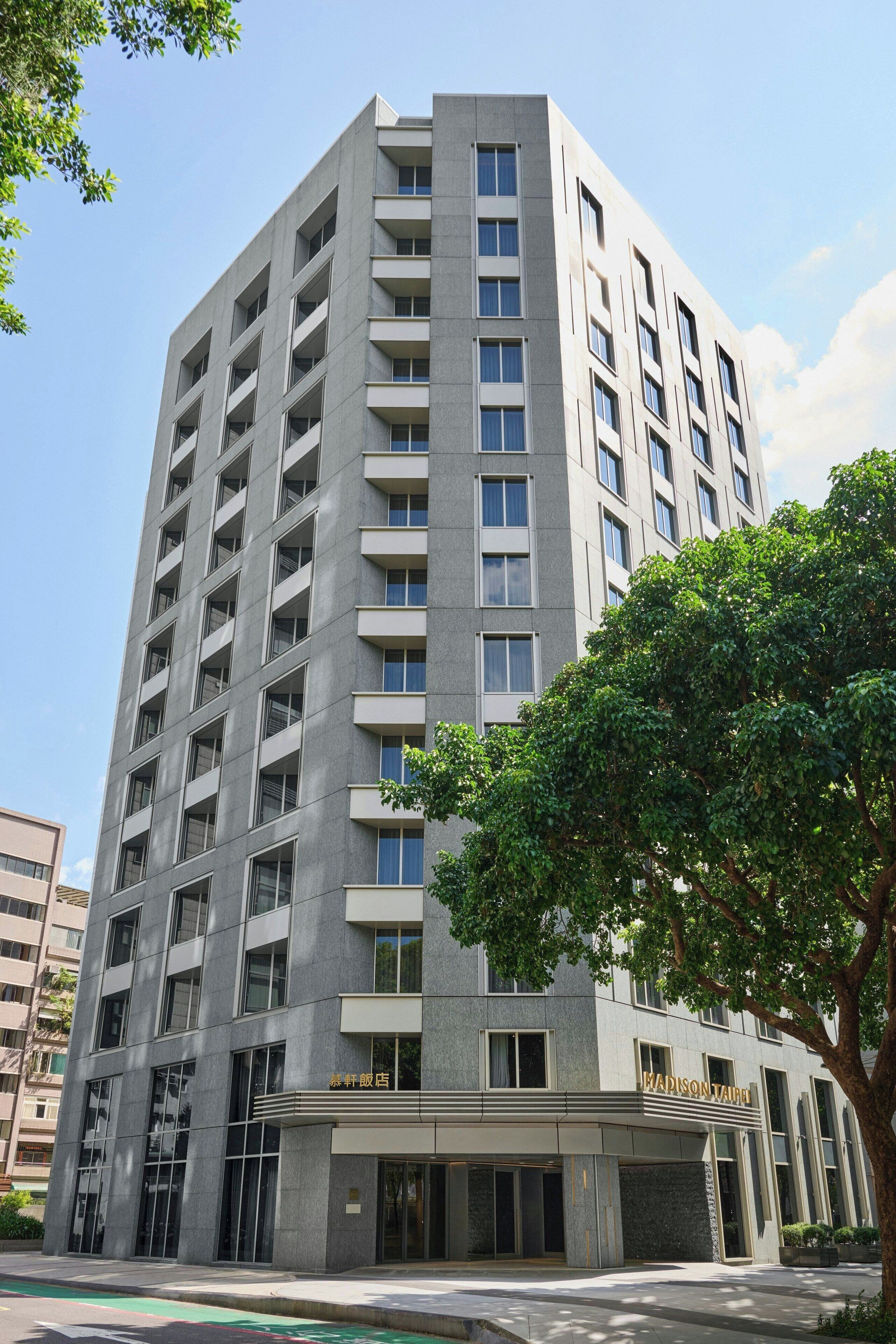 A high-rise hotel with a modern design, featuring multiple balconies and a prominent entrance.