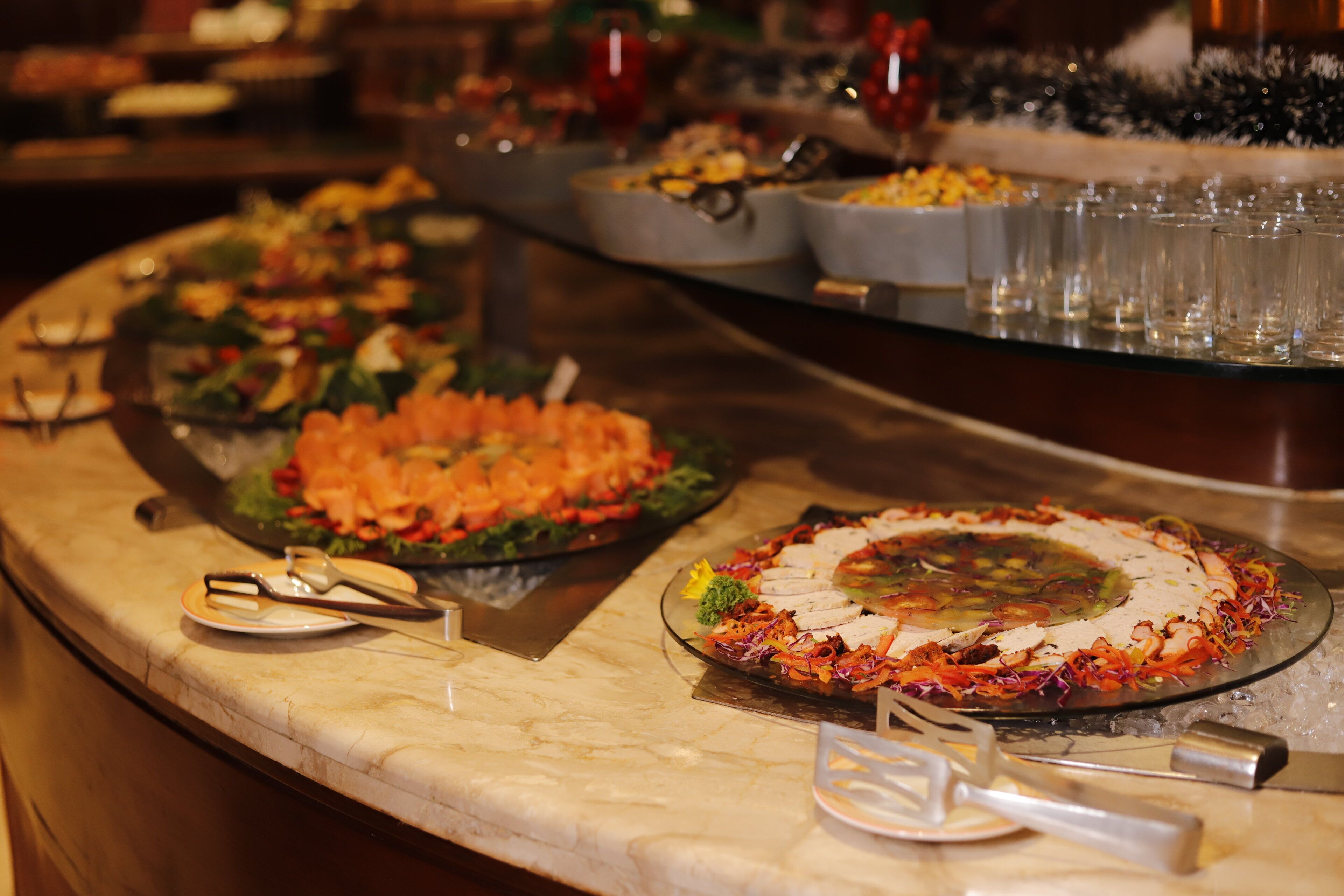 A buffet with various dishes and utensils.
