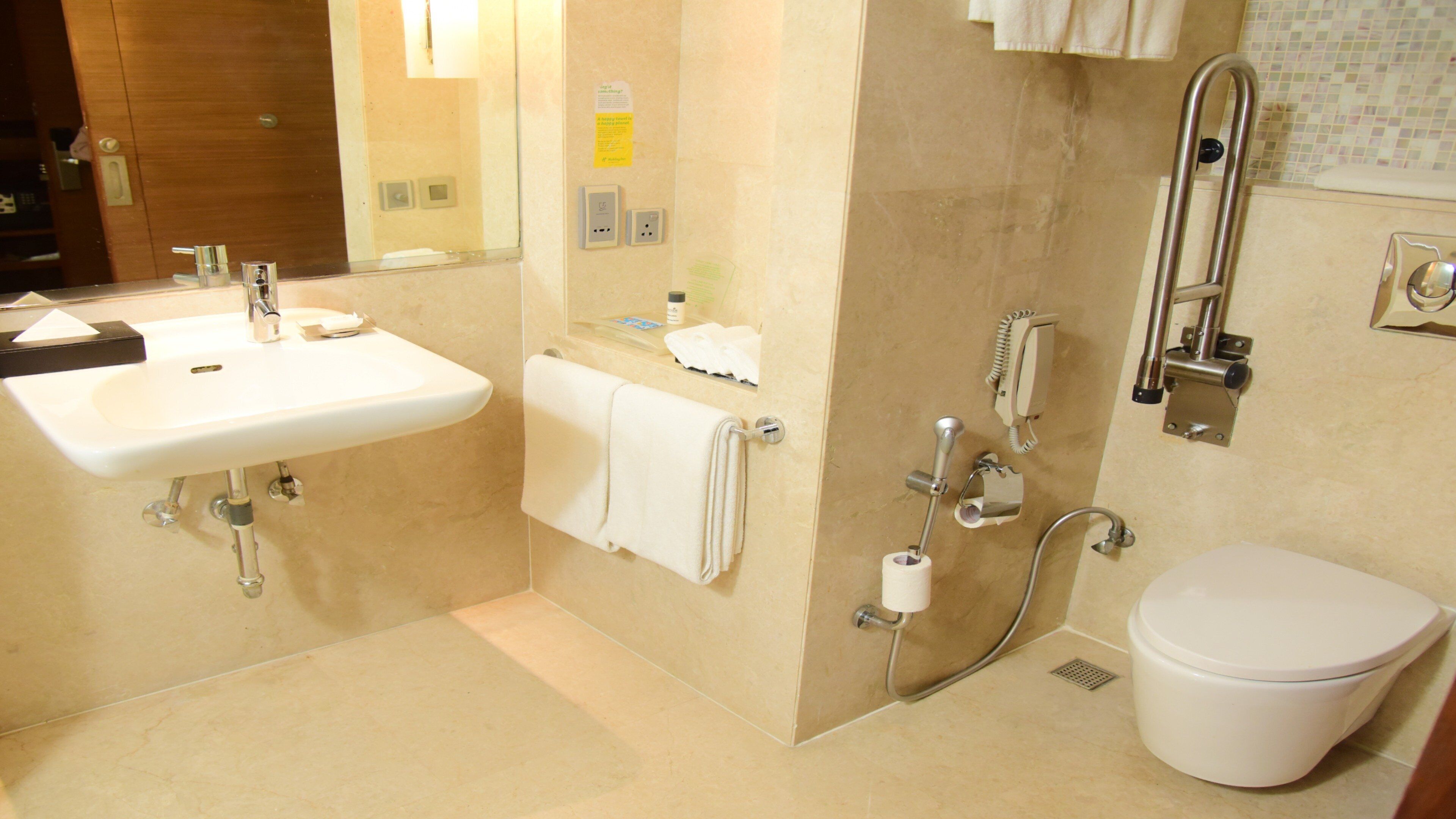 A bathroom with a sink, toilet, and shower.
