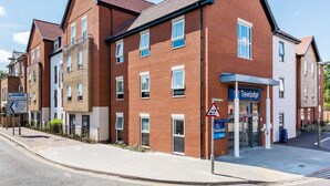 A Travelodge hotel with a brick facade, multiple windows, and a reception area. - Travelodge Chertsey (Chertsey)