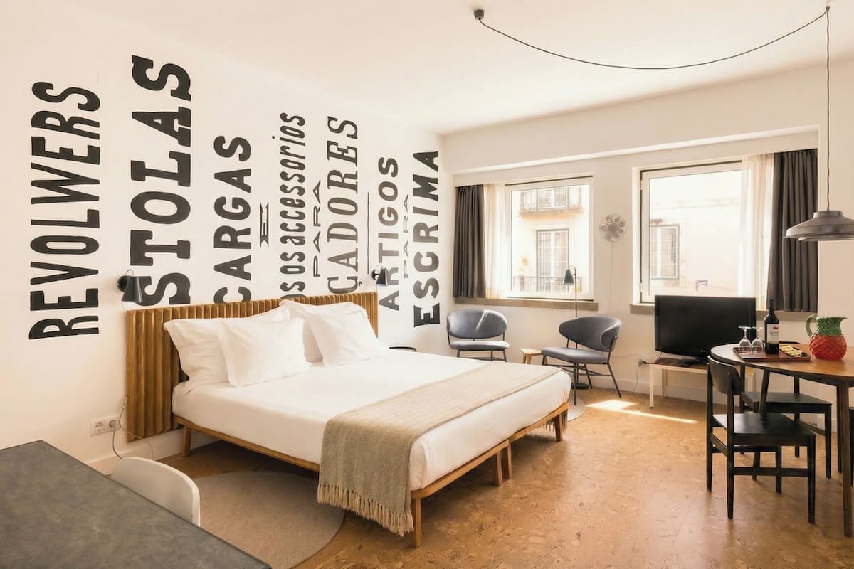 Een moderne hotelkamer met een bed, een bureau en een televisie.
