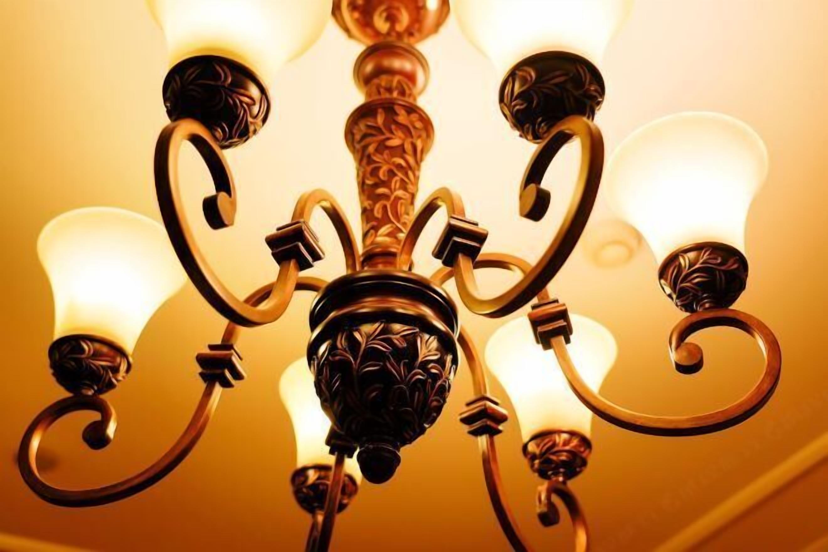 A chandelier with multiple light fixtures and ornate metalwork.