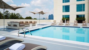 A rooftop pool area with lounge chairs, a sofa, and umbrellas. - Hyatt Regency Atlanta Perimeter at Villa Christina (Atlanta)