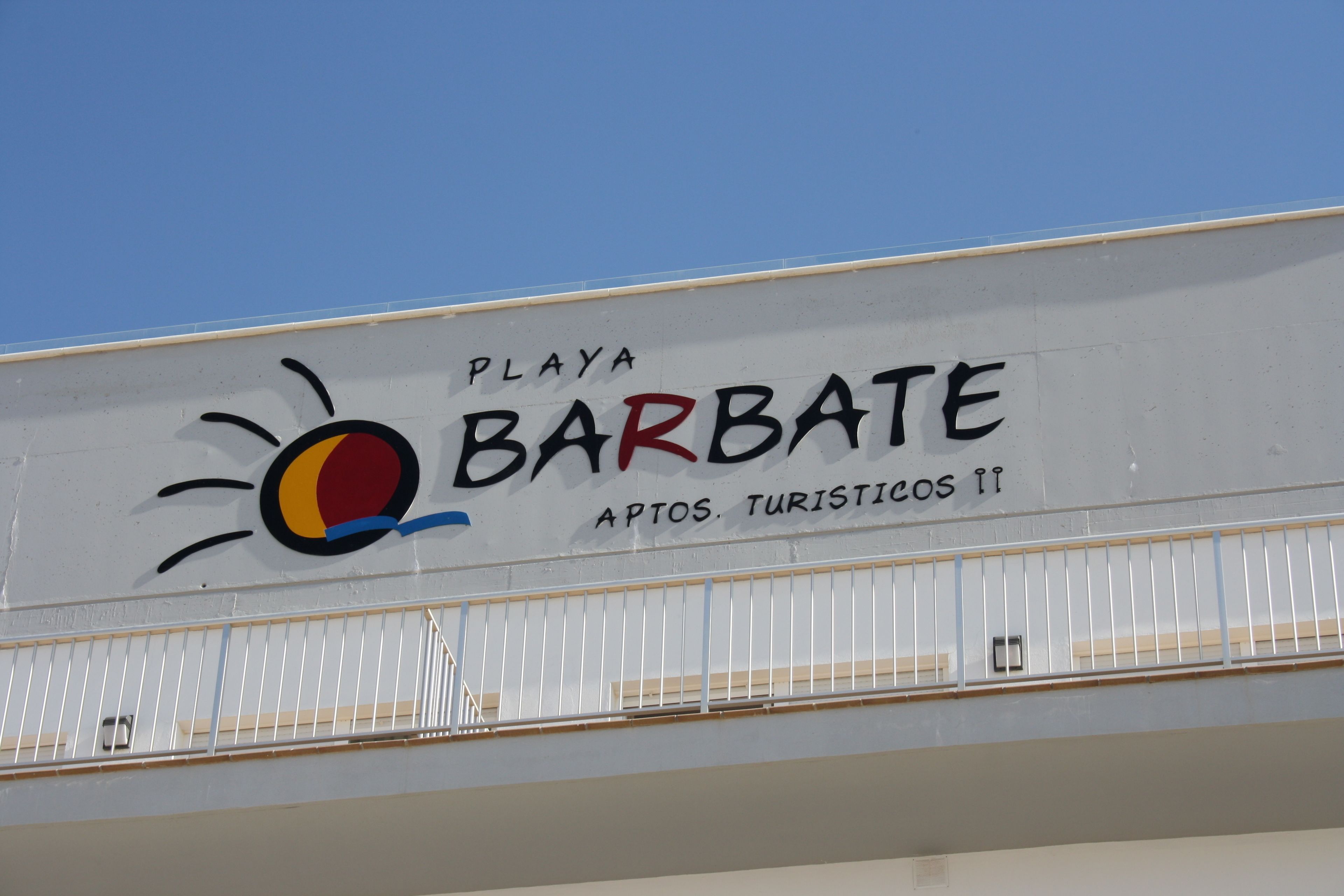 A sign with the text "PLAYA BARBATE" and a sun graphic.