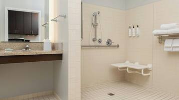 A modern bathroom with a shower, toilet, and sink.