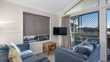 Deluxe Cabin - Sleeps 5 | Living area | Flat-screen TV, DVD player