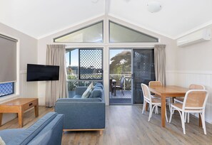 Deluxe Cabin - Sleeps 5 | Living area | Flat-screen TV, DVD player - Reflections Massy Greene - Holiday Park (Brunswick Heads)
