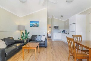 Deluxe Cabin - Sleeps 4 | Living area | 32-inch TV with digital channels