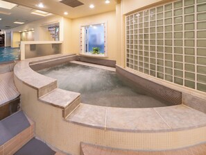 A hot tub area with tiled steps and a window with a view. - Capsule inn Osaka - Caters to Men (Osaka)