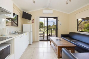 Standard Cabin - Sleeps 6 | Living area | Flat-screen TV
