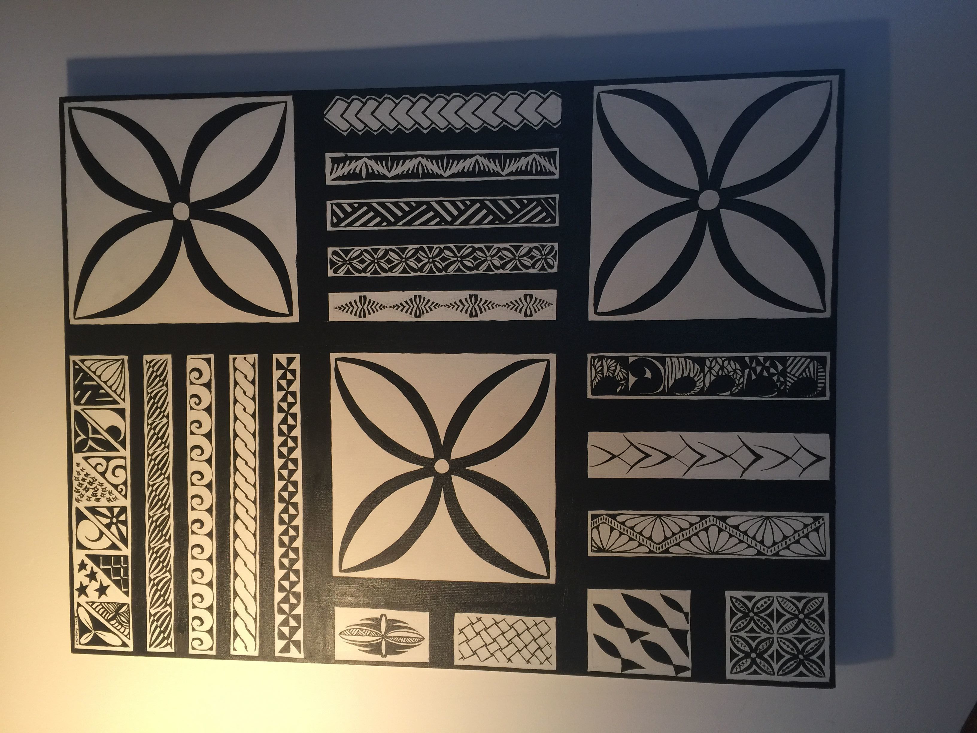A wall with various geometric and floral patterns.