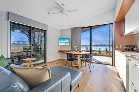 Premium Cabin - Sleeps 5 | Living area | 52-cm flat-screen TV with digital channels, DVD player. Reflections Urunga - Holiday Park