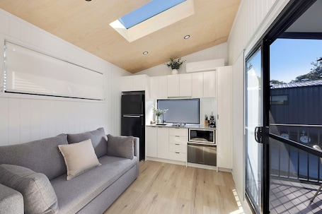 Premium Tiny Home - Sleeps 2 | Living area | 32-inch flat-screen TV with cable channels, LCD TV. Reflections Mylestom - Holiday Park