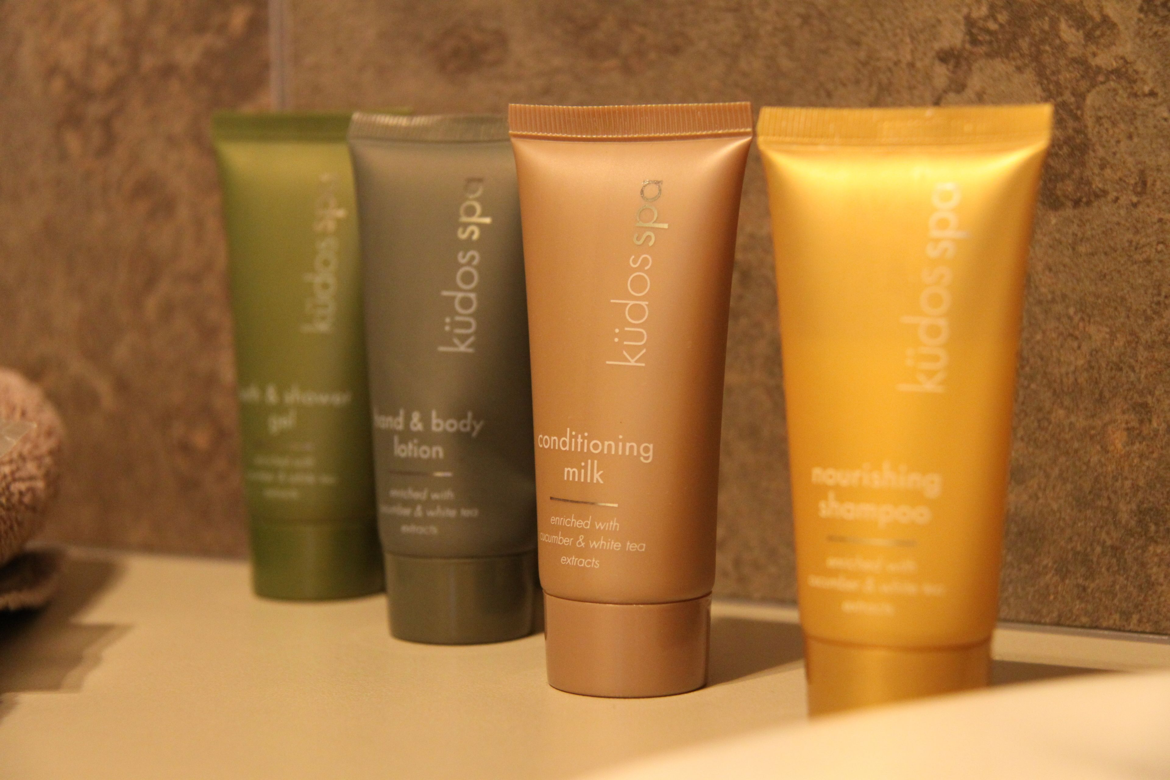 A row of four skincare products on a countertop.