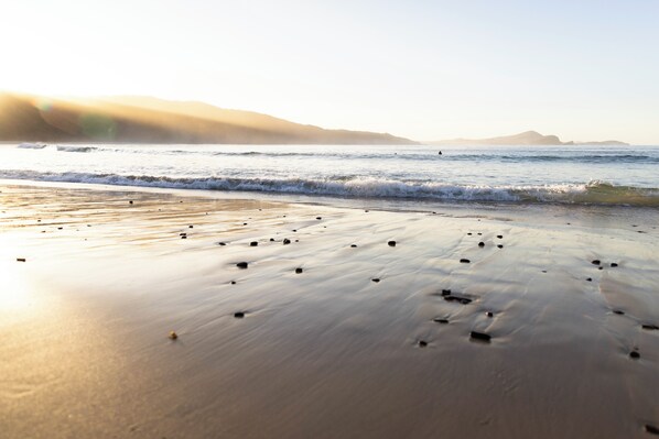 On the beach, surfing