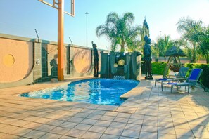 Outdoor pool, open 6:00 AM to 10:00 PM, pool loungers