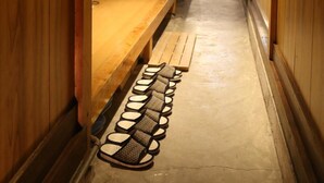 A wooden interior hallway with a staircase leading to another room. - Guesthouse Tomaru (Takayama)