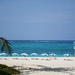 On the beach, white sand, sun loungers, beach umbrellas