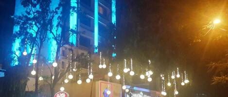 A building with multiple illuminated signs, including a prominent 'Royal' sign and a 'Royal Suite' sign.