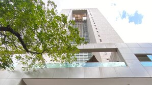 A modern building with a prominent entrance, a staircase leading up to the main doors, and a logo for Transamerica.