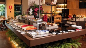 A buffet setup with various food items and a decorative centerpiece.