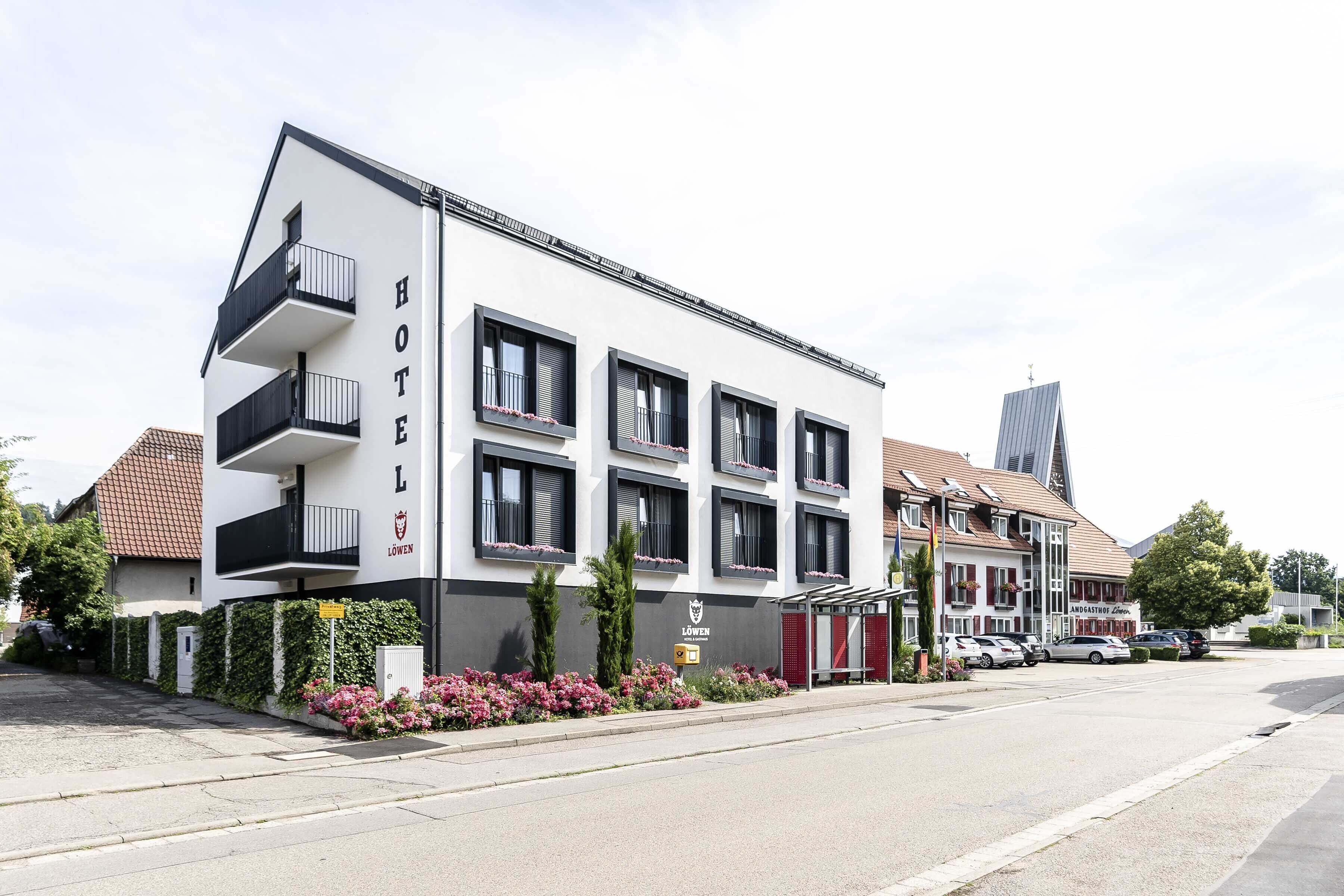 Un hôtel au design moderne, doté de balcons et d’une enseigne indiquant qu’il s’agit d’un bâtiment de faible hauteur.