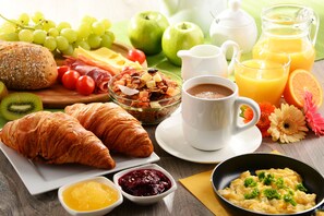 Enjoy a delicious breakfast spread with fresh fruits, warm pastries, and a selection of beverages.