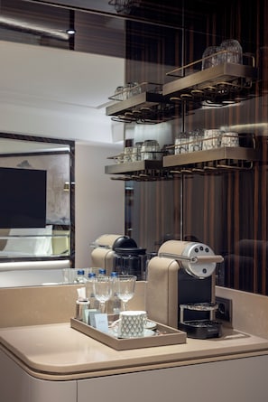 A modern hotel room with a minibar, a coffee machine, and a tray with glasses and toiletries. - The Ritus Hotel Istanbul Sultanahmet, Tapestry Collection by Hilton (Istanbul)