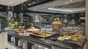 A buffet with various food items, including bread, pastries, and fruits. - The Ritus Hotel Istanbul Sultanahmet, Tapestry Collection by Hilton (Istanbul)