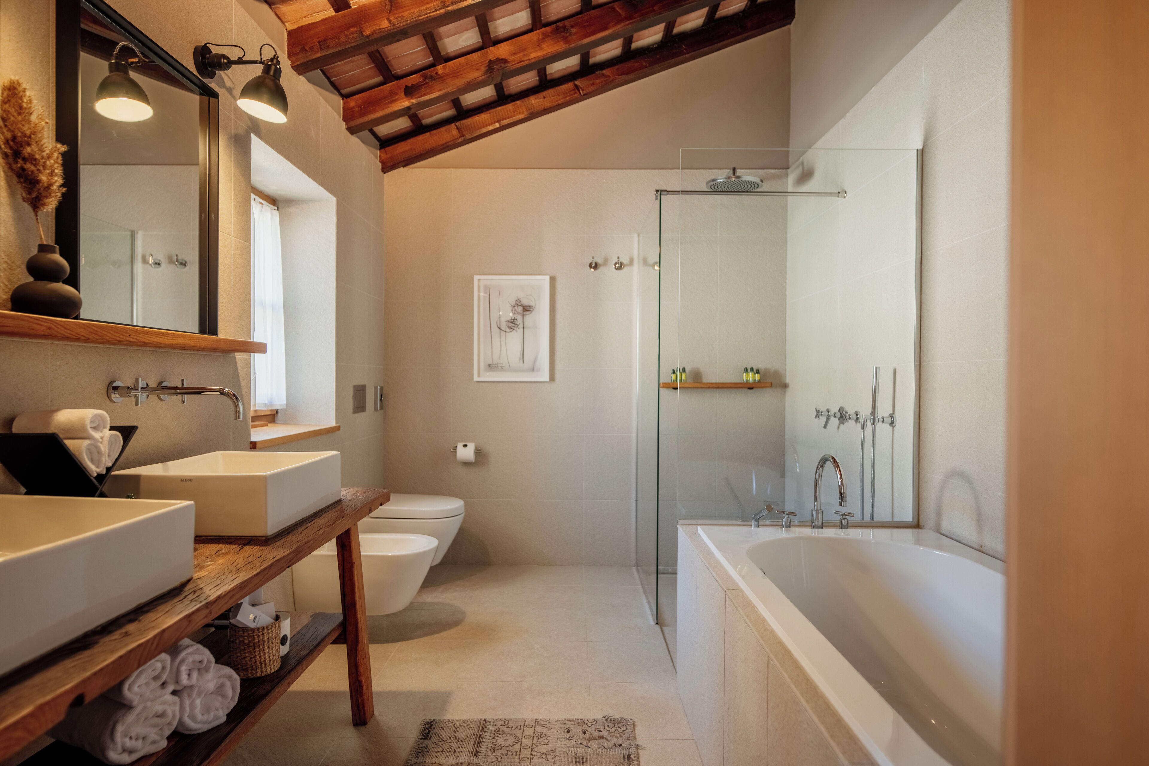 Une salle de bain moderne dotée d’une grande baignoire, d’une douche séparée et d’un meuble-lavabo avec deux vasques.