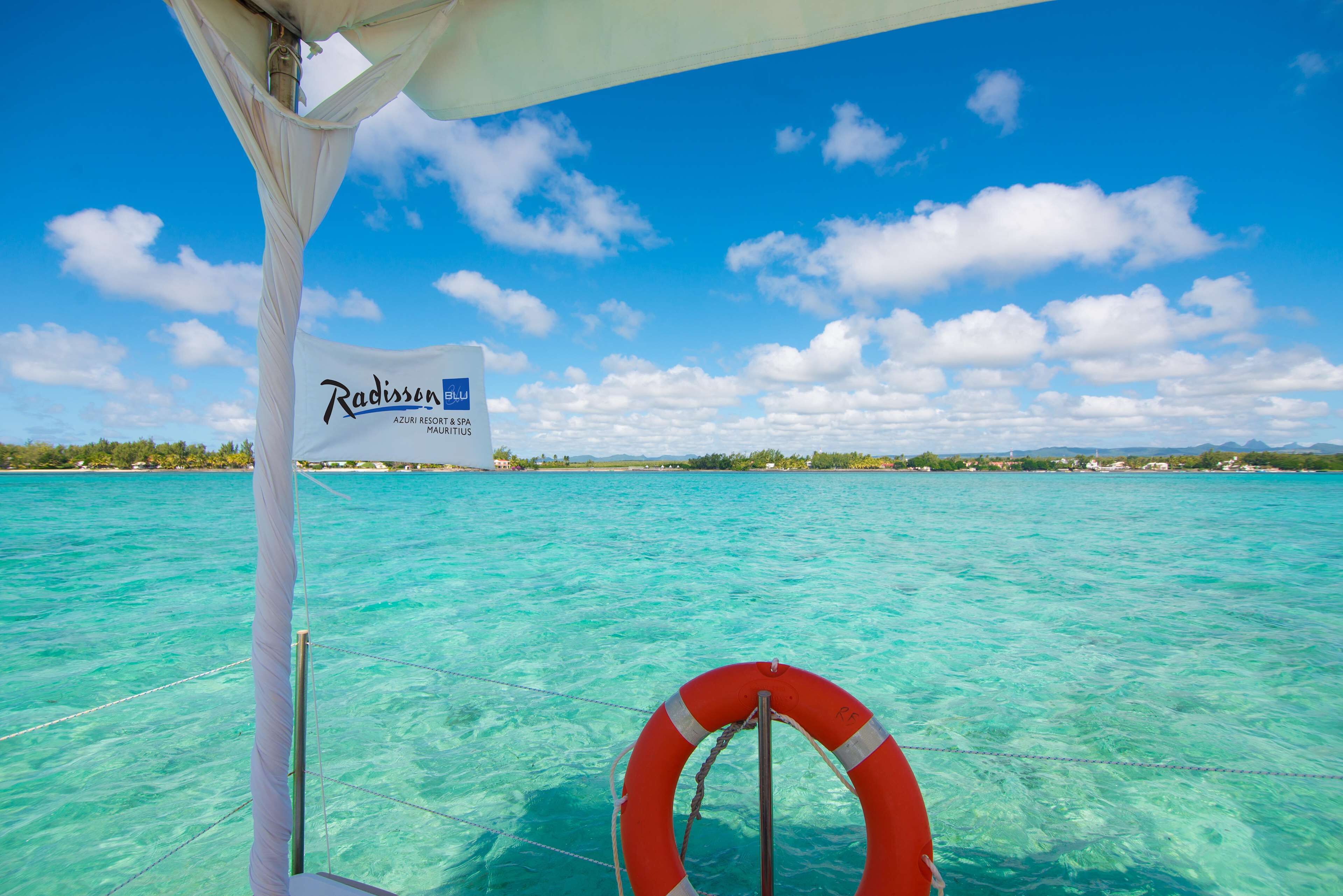 on the beach, beach umbrellas, beach towels, windsurfing