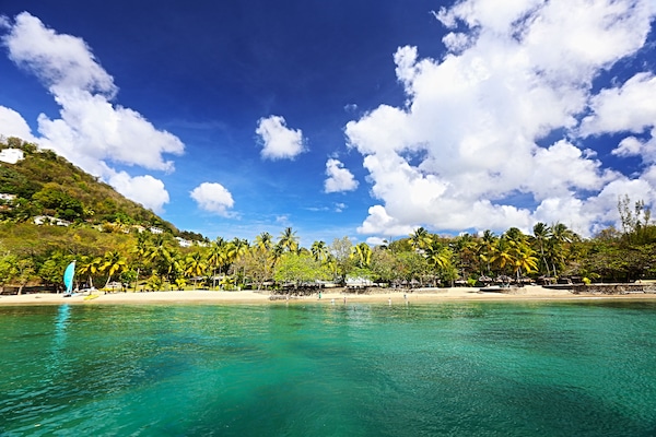 On the beach, white sand, sun loungers, beach towels