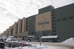 A multi-story hotel with a large sign reading "Silver Creek." - Silver Creek Lodge (Snowshoe)