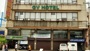 A building with a sign reading "GV HOTEL" and a smaller sign below stating "VISMIN GV HOTEL FIRE PREVENTION MONTH 2014".