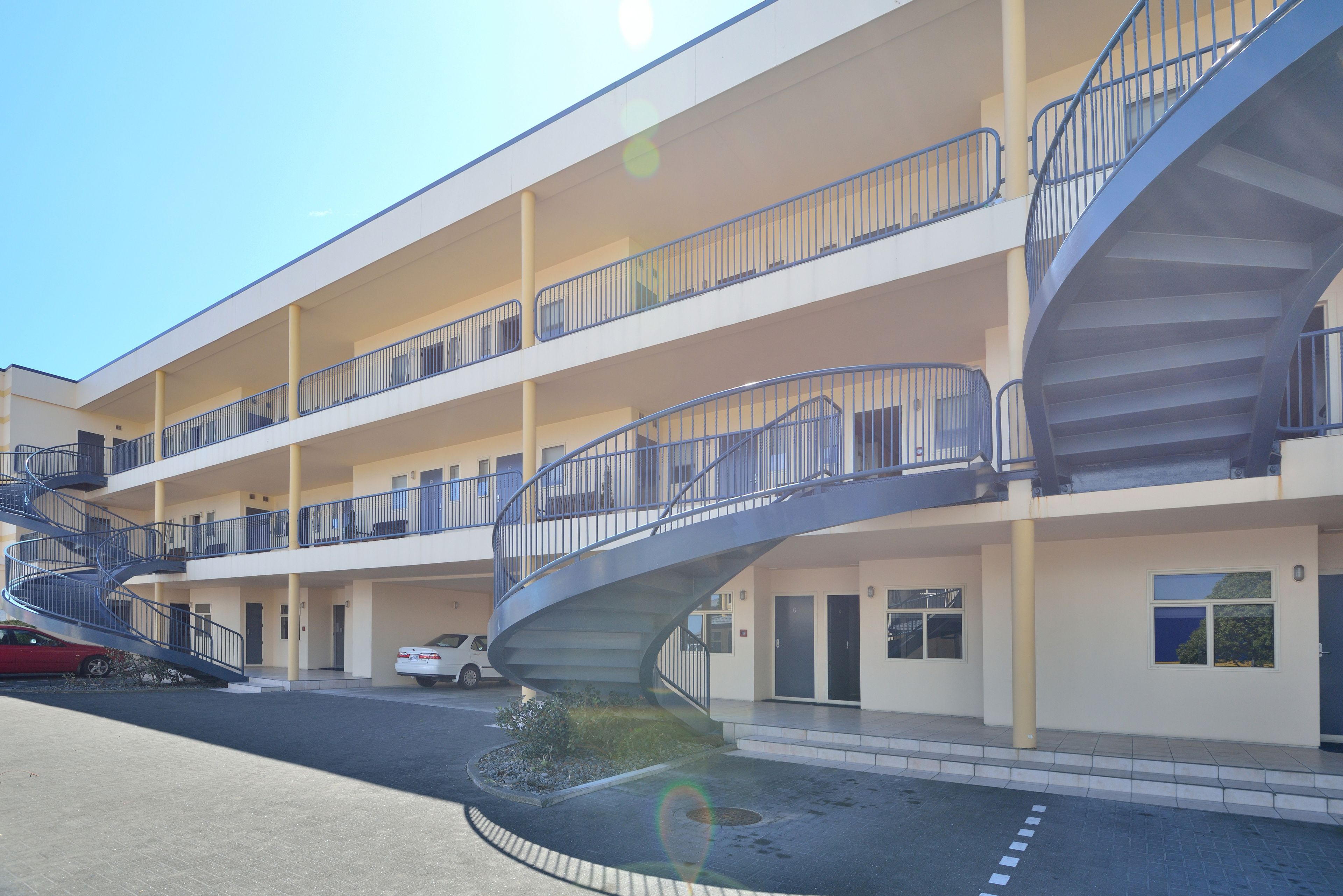 A multi-story building with a central spiral staircase connecting the floors.