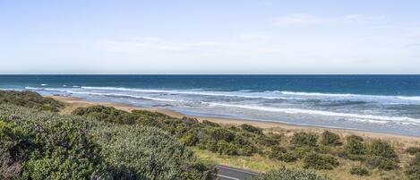 A coastal road with a beach and ocean view.